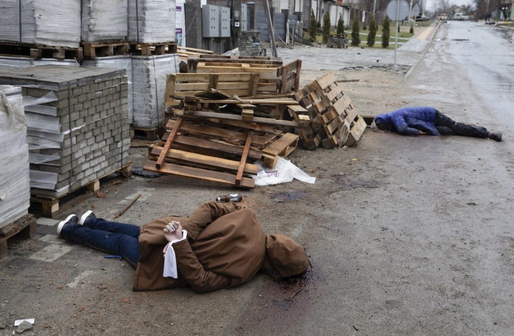 Bodies of murdered civilians lie in the streets