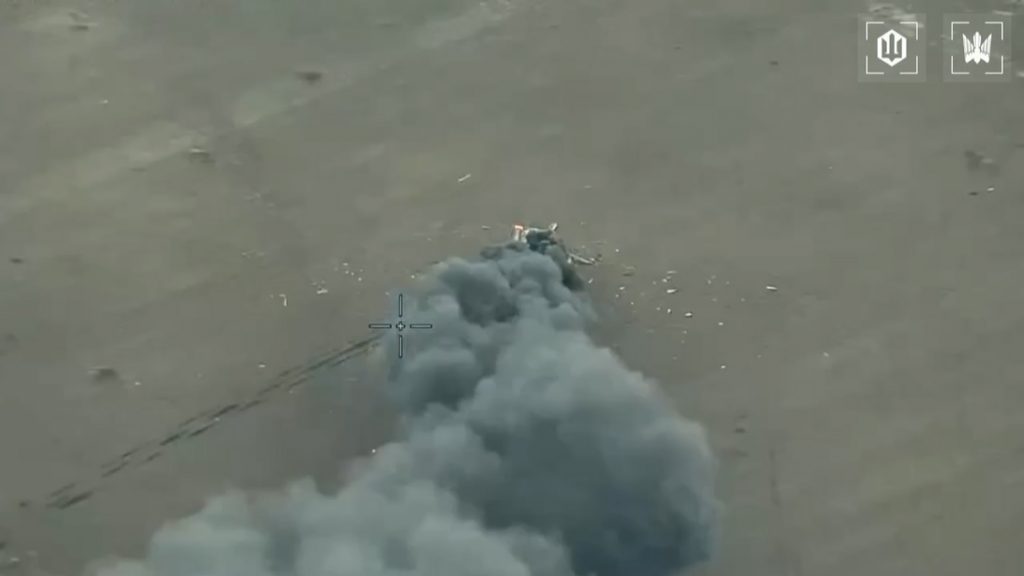 Russian Ka-52 helicopter burns on the ground after being hit by a Ukrainian FPV drone.