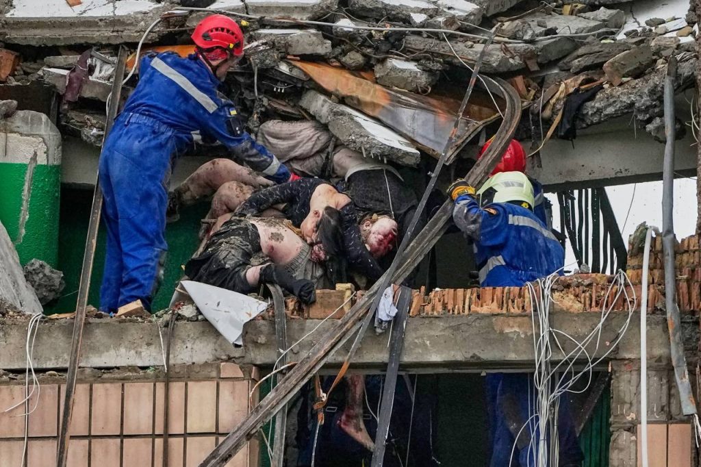 Emergency first responders looking at the ruins of a residential home hit by a missile